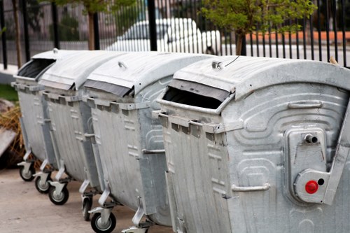 Professional waste removal team handling furniture