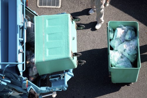 Worker wearing personal protective equipment handling waste