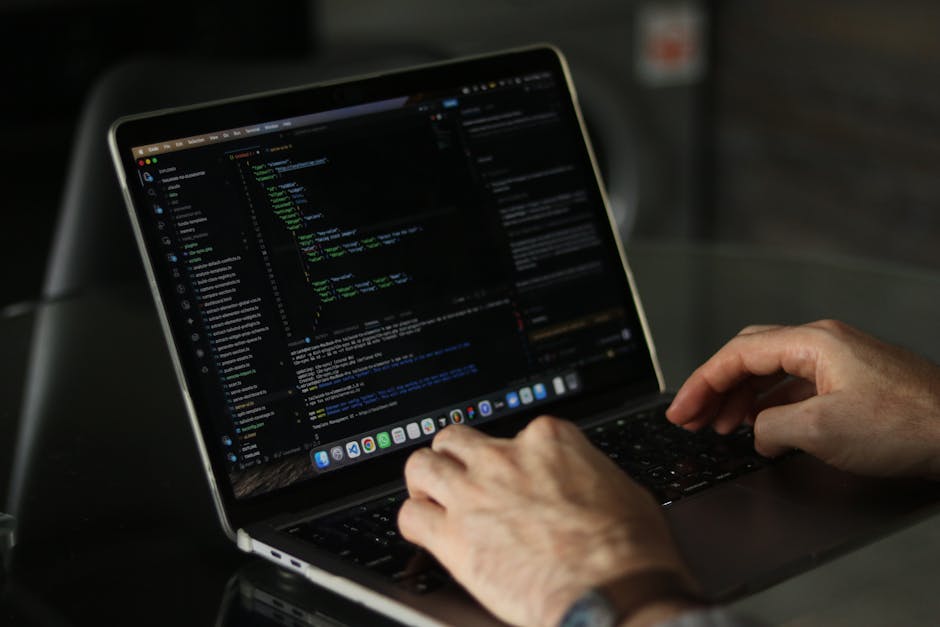 A close-up photograph of a computer screen displaying lines of CSS code in various colors including blue, yellow, purple, and green. The code appears to be part of a stylesheet with properties such as